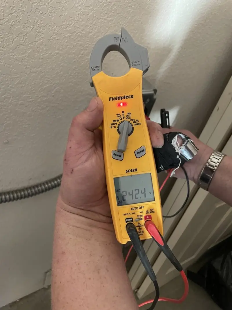 Voltage testing with clamp meter during Recessed Lighting Installation in Godley
